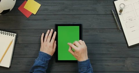 Top view on the black tablet device lying vertically on the dark grey wooden Stock Footage 96328830