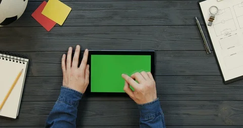 Top view on the black tablet device lying horizontally on the dark grey wooden Stock Footage 96329130