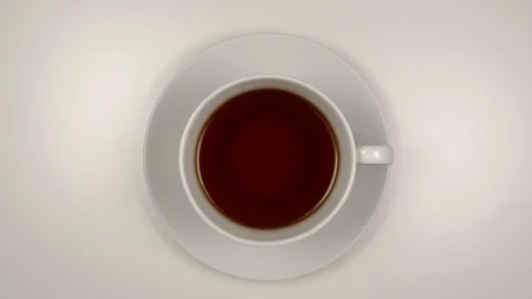 TOP VIEW: Black tea Drinking from a white teacup on a table - Stop motion Stock Footage 125290334