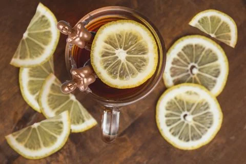 Top view of black tea with lemon in cup on wooden plank table. and two athletic Stock Illustration