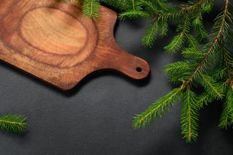 Top View Black Textured Table with Green Branches and Empty Cutting Board. Ol Stock Photos