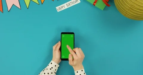 Top view on the black vertical smartphone lying on the blue table with Happy Stock Footage 89313020