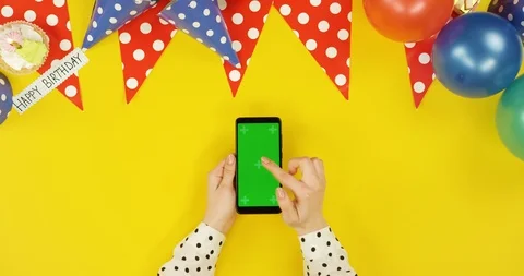 Top view on the black vertical smartphone on the yellow table with birthday Stock Footage 89316660