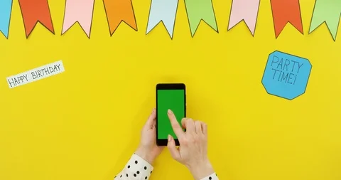 Top view on the black vertical smartphone on the yellow table with decorations Video stock 89331361