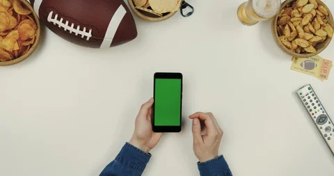 Top view on the black vertical smartphone device on the white desk with rugby Stock Footage 96325700