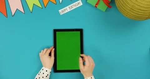 Top view on the black vertical tablet device lying on the blue table with Happy 스톡 동영상 89312910