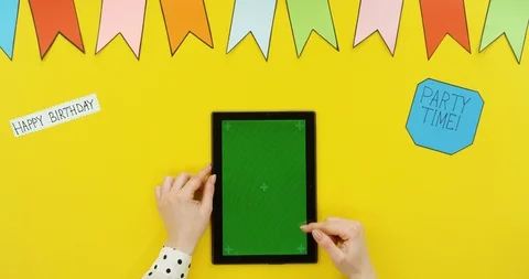 Top view on the black vertical tablet on the yellow table with decorations 스톡 동영상 89332218