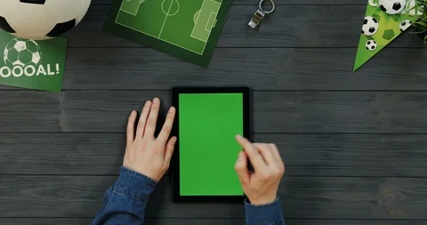 Top view on the black vertical tablet computer on the dark grey wooden desk of Stock Footage 96439986