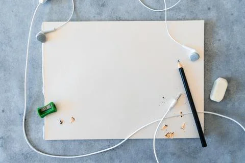 A top view of blank drawing sheet with a sharp pencil, sharpener, eraser and  库存照片