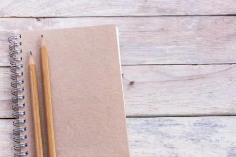 Top view with blank empty notepad and pencil on wood table. Stock Photos