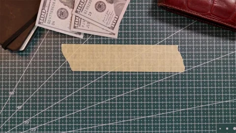 Top view of blank masking tape mockup with hundred dollar bills and wallet Stock Footage 338183856