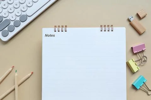 Top view of blank note book and pencil, keyboard, binder clip  Stock Photos