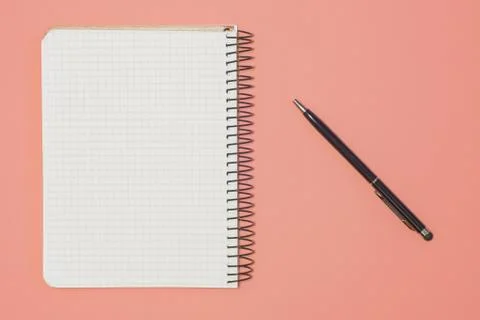 Top view of blank note paper with pen on Living Coral Trend for background. B Stock Photos