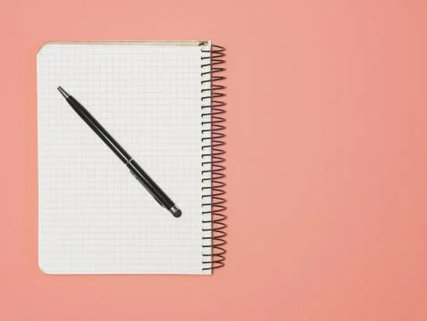 Top view of blank note paper with pen on Living Coral Trend for background. B Stock Photos