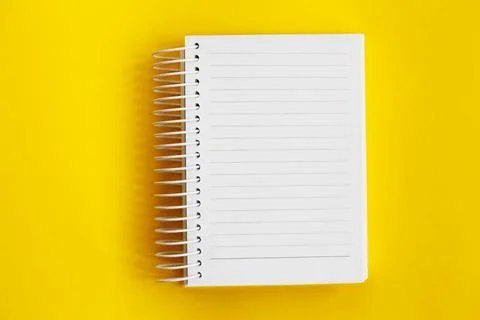 Top view of blank note paper on yellow background Foto stock