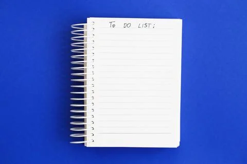 Top view of blank note paper on blue background. to do list Stock Photos