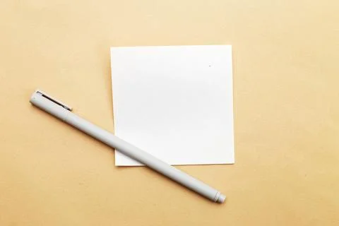 Top view of blank note paper with pen on beige background 스톡 사진