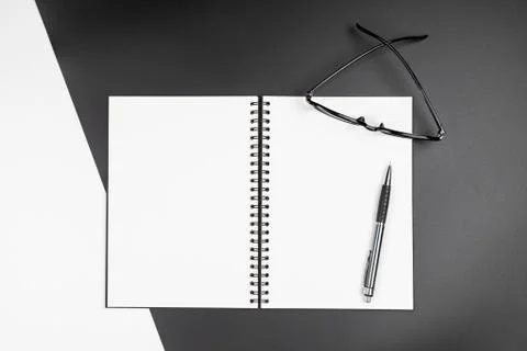 Top view of  blank notebook and pencil on black and white background Stock Photos
