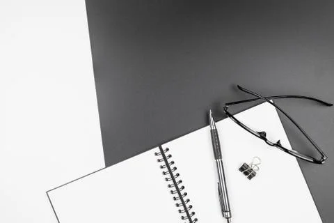 Top view of  blank notebook and pencil on black and white background Stock Photos