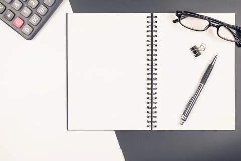 Top view of  blank notebook and stationery on black and white background Stock Photos