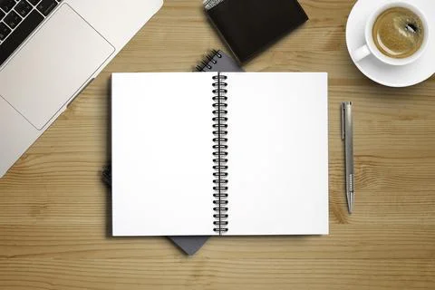 Top view of blank notebook memo on working desk among coffee cup and laptop Stock Photos