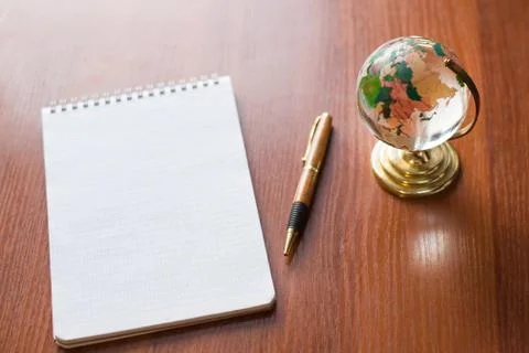 Top view of Blank notebook white paper and globe world map on wooden backgrou 스톡 사진