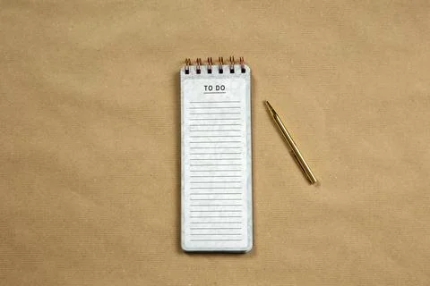 Top View of blank Notepad with empty To Do list on brown paper background, copy Stock Photos