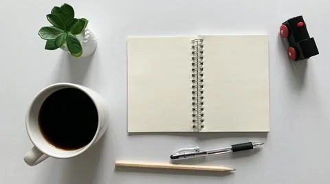 Top view of blank notepad, pen and coffee with white background. Stock Photos