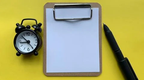 Top view of blank notepad with yellow background. Stock Photos