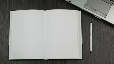 Top view of blank open diary on office table. Businessman's hand turns the page. Video stock 96988926