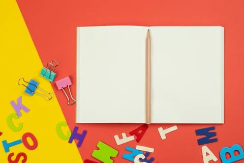 Top view of blank open notebook with pencil and alphabets Stock Photos