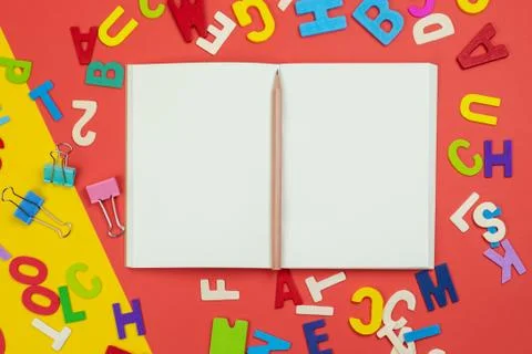 Top view of blank open notebook with pencil and alphabets Stock Photos
