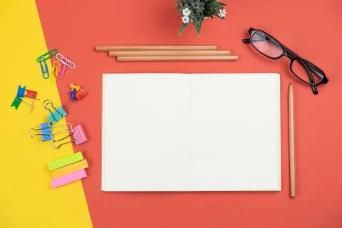 Top view of blank open notebook with pencil and stationery items and eyeglass Stock Photos