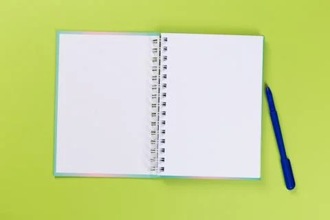 Top view of blank open notebook or notepad on green background, office equipm Stock Photos