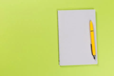Top view of blank open notebook or notepad on green background, office equipm Stock Photos