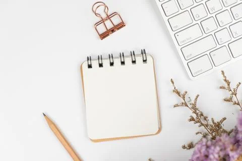 Top view of a blank paper note with pencil and flower bouquet Stock Photos