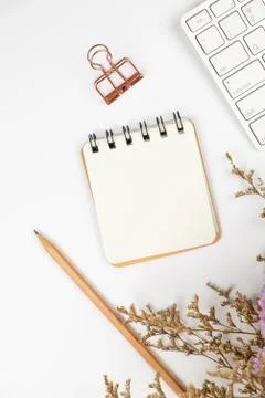 Top view of a blank paper note with pencil and flower bouquet Stock Photos
