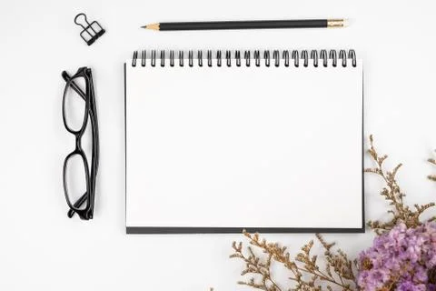 Top view of a blank paper note with pencil and flower bouquet Stock Photos