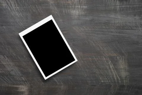Top view of blank photo frames on wooden table background. Stock Photos