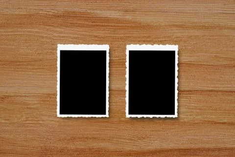 Top view of blank photo frames on wooden table background. Stock Photos