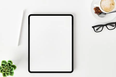 Top view of blank screen tablet on white working desk Stock Photos