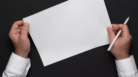 Top view of a blank sheet of paper and a businessman's hands Stock Footage 130845460