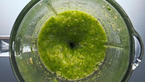Top view blend vegetables swirling inside blender in super slow motion close up. Stock Photos