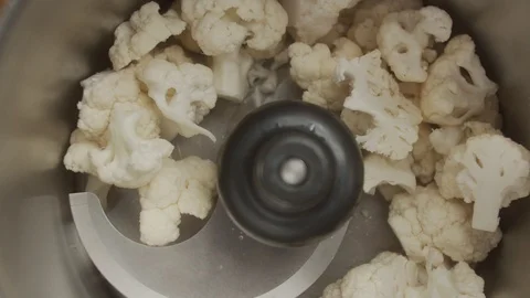 Top view blender grinds slices of cauliflower. Slow motion video Stock Footage 123051884