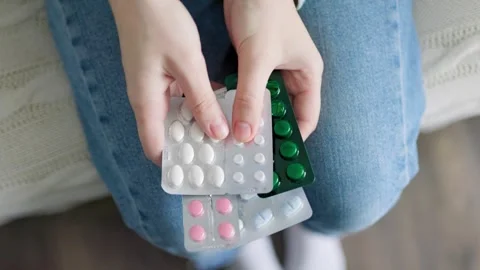 Top view blisters with tablets in palms, hands of unrecognizable, girl sitting Stock Footage 304805491
