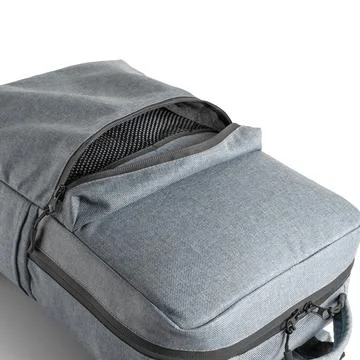 Top view of a blue backpack with an open additional pocket for various items. Stock Photos