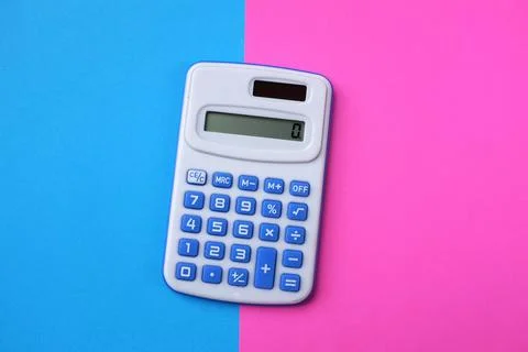 Top view A blue calculator on the two tone color blue and pink background Stock Photos
