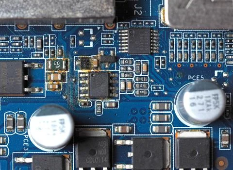 Top view of the blue electronic Board with oxidized contacts, capacitors and  Stock Photos
