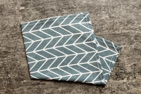 Top view with blue kitchen napkin isolated on table background. Folded clot.. Stock Photos