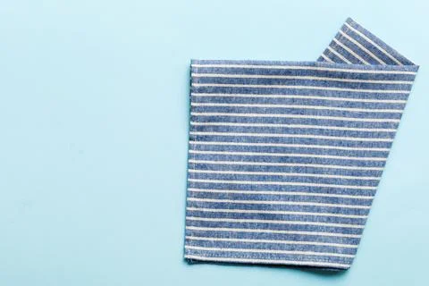 Top view with blue kitchen napkin isolated on table background. Folded cloth  Stock Photos